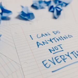 Handwritten motivational quote on lined paper with crumpled notes around, emphasizing self-empowerment.